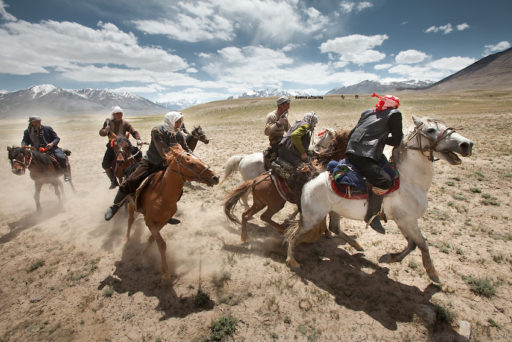Kyrgyz men fight in a game of Buzkashi, a competition akin to polo—except a headless goat carcass takes the place of the ball. Buzkachi is almost exclusively played during weddings. Probably one of the great pleasures in the life of a Kyrgyz man, Buzkashi is Afghanistan’s national sport. The Kyrgyz call it ulak tartysh, or “goat grabbing.” At the wedding celebration at Kitshiq Aq Jyrga. Trekking through the high altitude plateau of the Little Pamir mountains (average 4200 meters) , where the Afghan Kyrgyz community live all year, on the borders of China, Tajikistan and Pakistan.